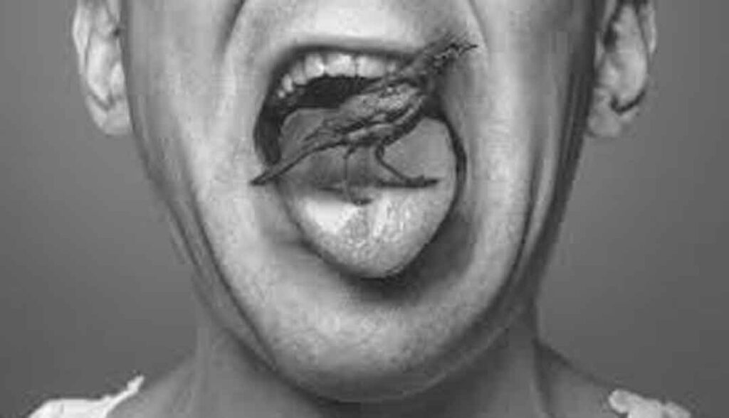 Boca abierta con lengua sacada y sobre la lengua un pequeño pájaro extraño